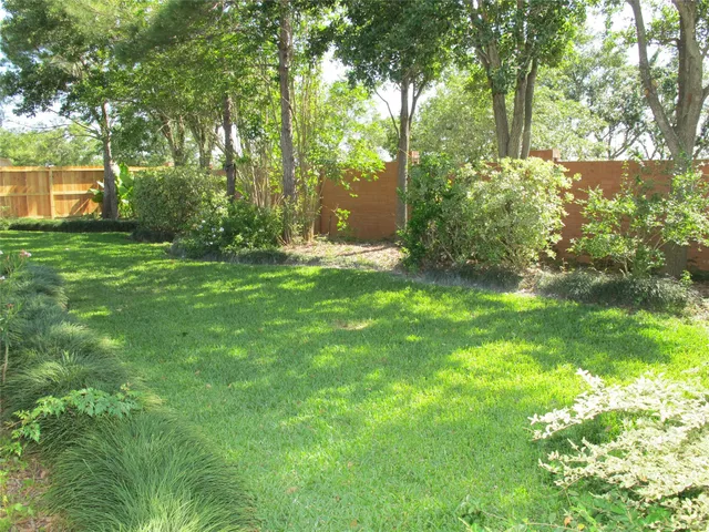 an aerial view of lake and residential houses with outdoor space