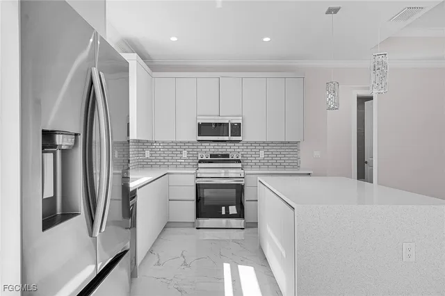 a kitchen with a refrigerator sink and stove