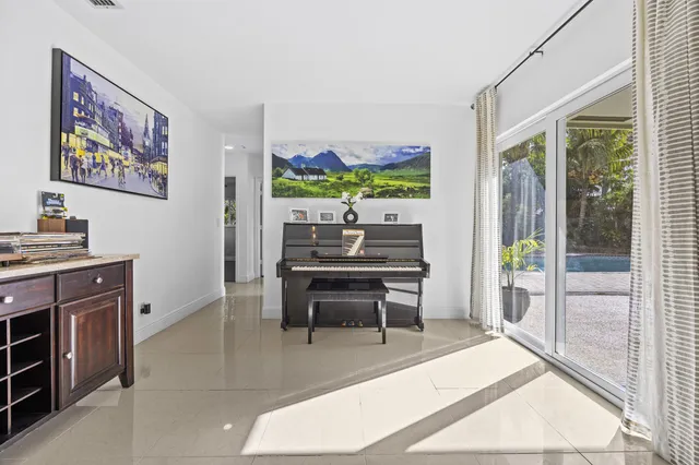 a bedroom with a bed a window and wooden floor