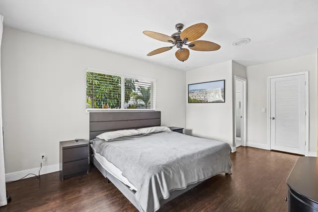 a bedroom with a bed and a large window