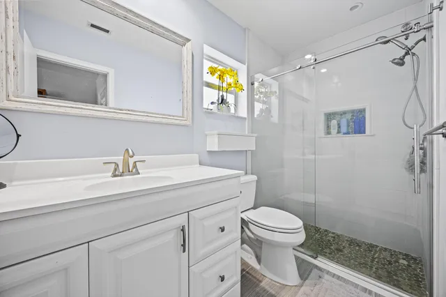 a bathroom with a sink a mirror and vanity