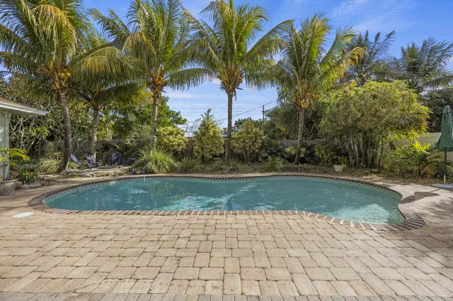 a view of a patio with table and chairs and potted plants