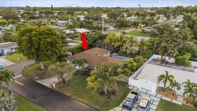an aerial view of residential houses with outdoor space and trees