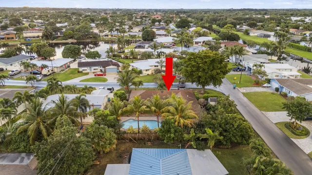 a view of a house with a yard and tree