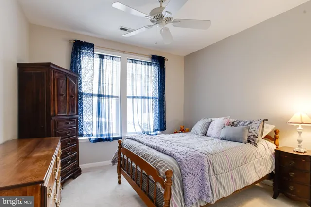 a spacious bedroom with a bed and a chandelier