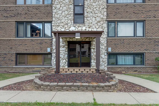 front view of a brick house with a sink and a window