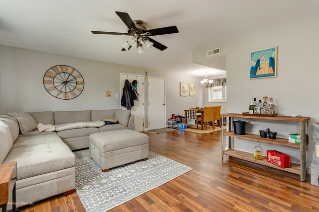 a living room with furniture and wooden floor
