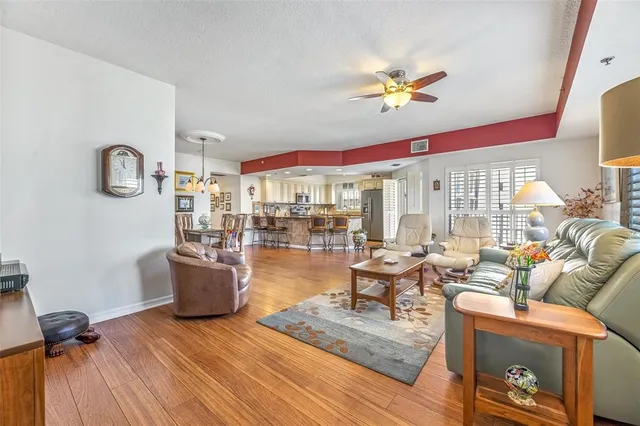 a living room with fireplace furniture and a large window