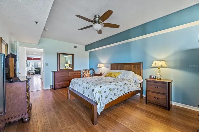 a bedroom with a bed and wooden floor