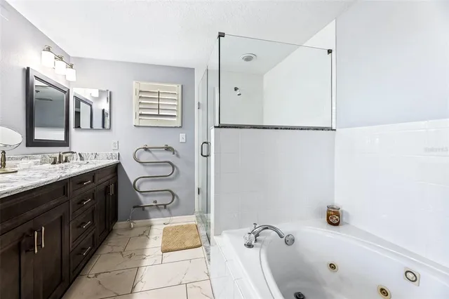 a bathroom with a tub sink and mirror