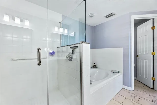 a bathroom with a bathtub and a shower