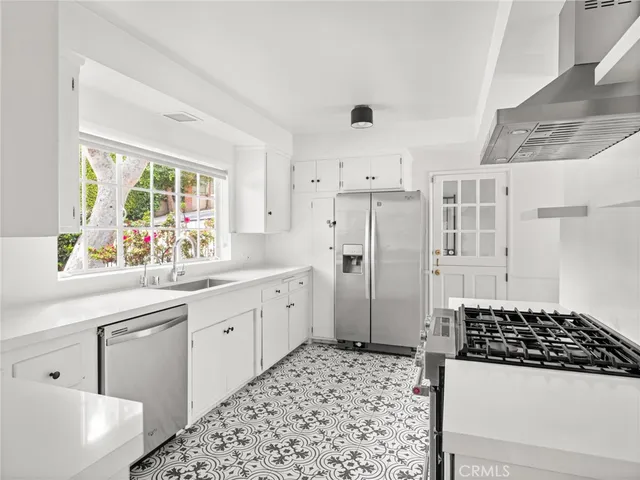 a kitchen with a refrigerator a sink and a window