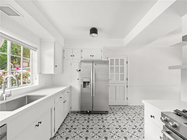a kitchen with a refrigerator and a sink