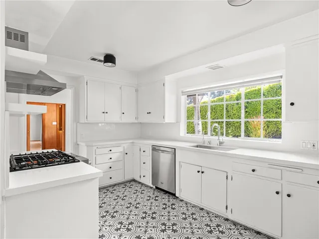 a kitchen with a stove a sink and a refrigerator