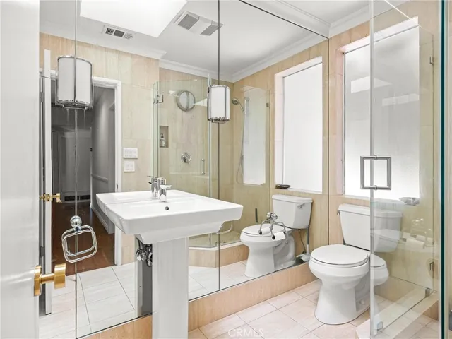 a bathroom with a sink toilet a mirror and shower