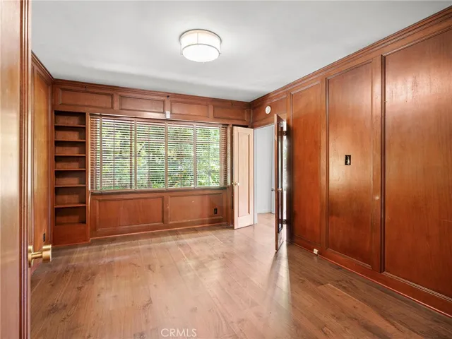 an empty room with windows wooden floor and windows