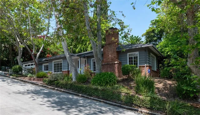 front view of a house with a tree