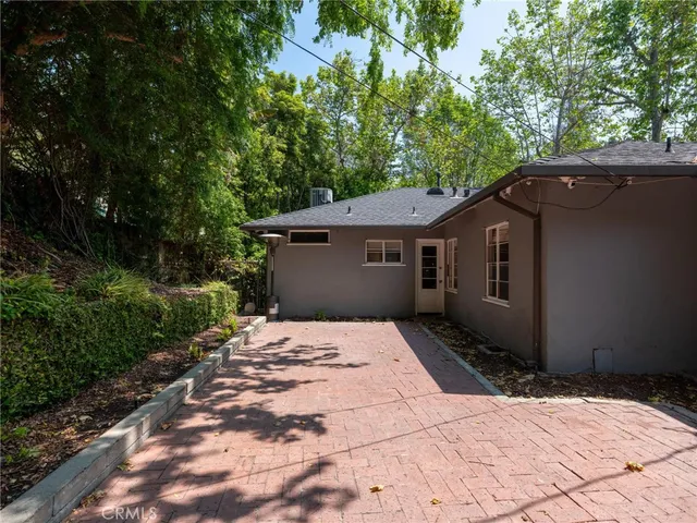 a backyard of a house with large trees
