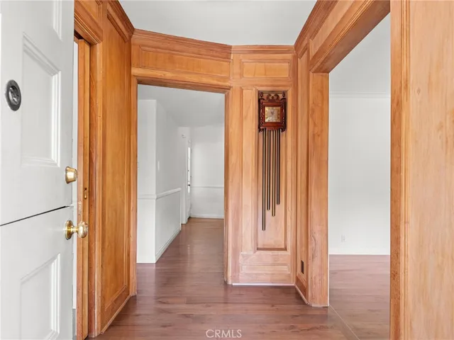 a view of a hallway with wooden floor and glass door