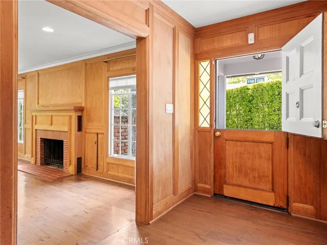 a view of a livingroom with a fireplace window and front door