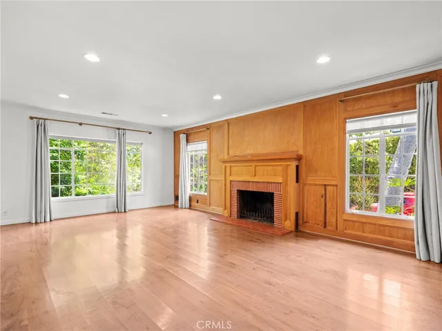 a view of an empty room with a fireplace and a window