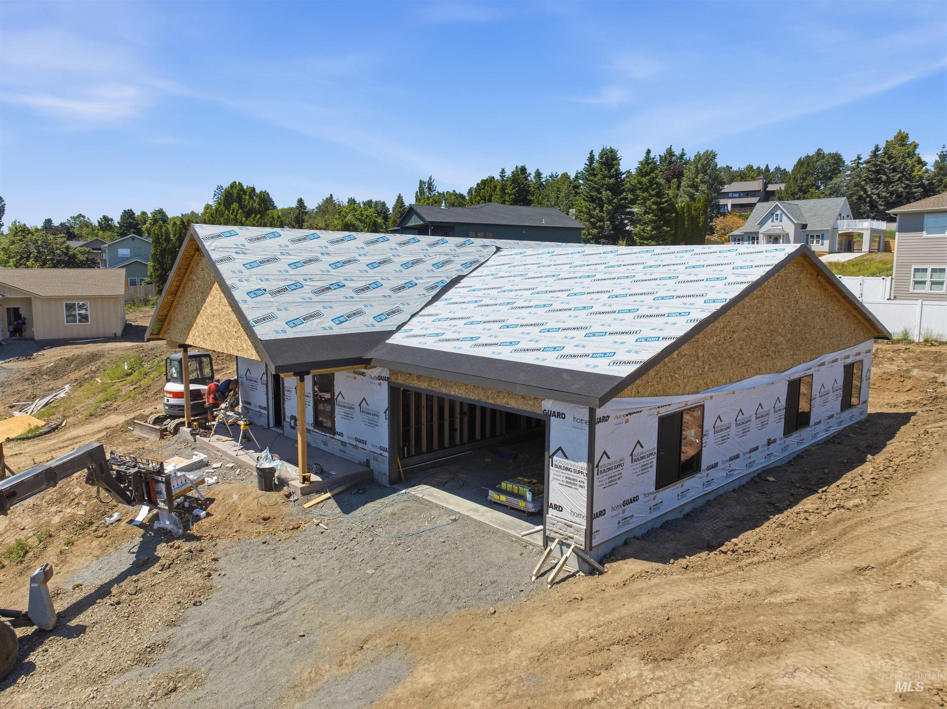 2824 Cyprus Court Moscow, ID 83843 - Photo 2 of 20 Contemporary-style residence under construction featuring dark gray siding, stone accents, and a covered front entry with wood posts