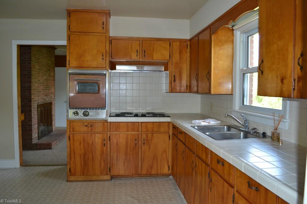 1463 Talbot Road Pleasant Garden, NC 27313 - Photo 7 of 13 Kitchen with tile counter tops, cooktop