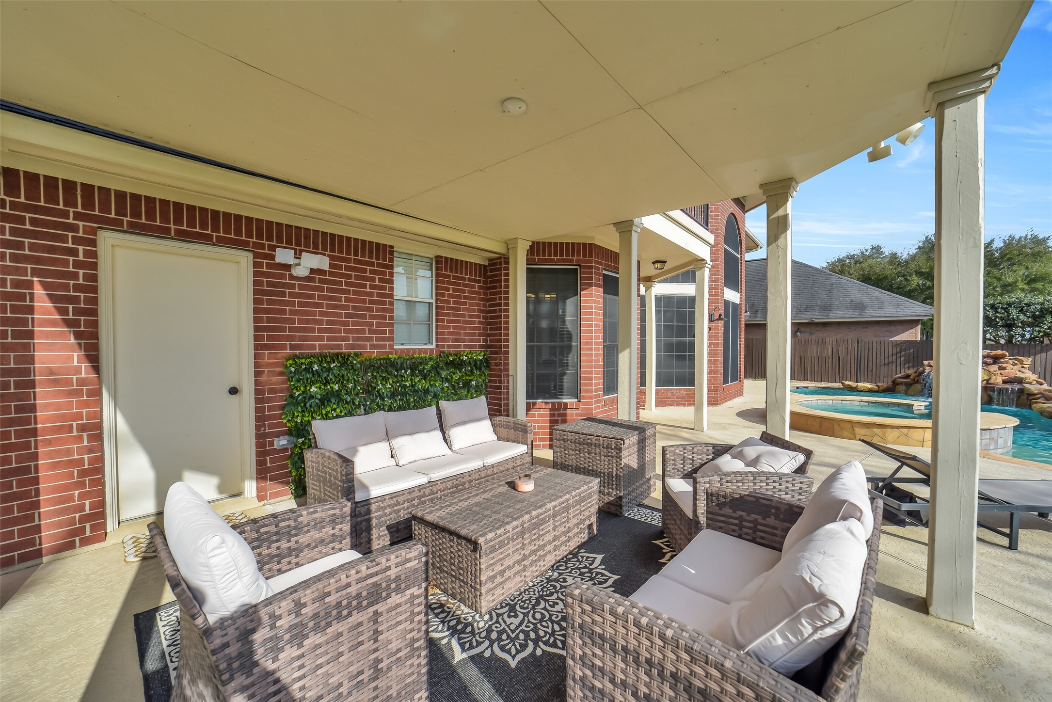 24403 Falcon Point Drive Katy, TX 77494 - Photo 13 of 32 Expansive covered outdoor patio, an ideal spot for outdoor dining or lounging while overlooking the pool.