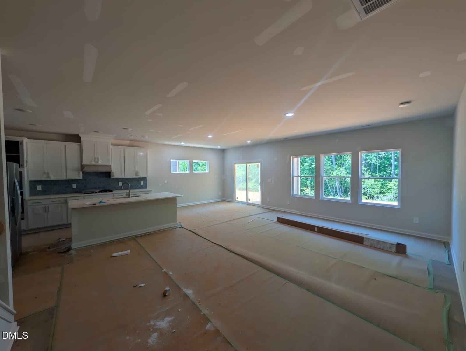 308 Karlov Road Garner, NC 27529 - Photo 9 of 55 a open kitchen with white cabinets and white appliances