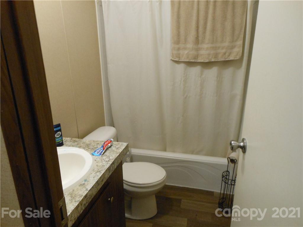 91 Foster Lake Road Blacksburg, SC 29702 - Photo 20 of 31 a bathroom with a granite countertop sink and a mirror