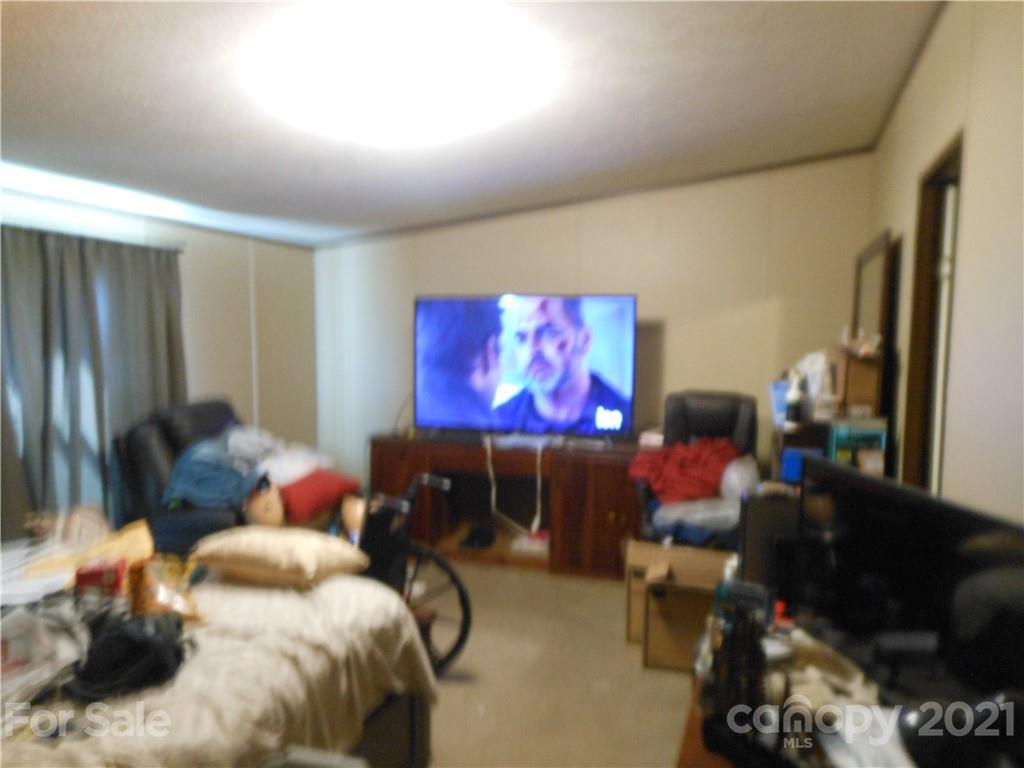 91 Foster Lake Road Blacksburg, SC 29702 - Photo 23 of 31 a living room with furniture and a flat screen tv