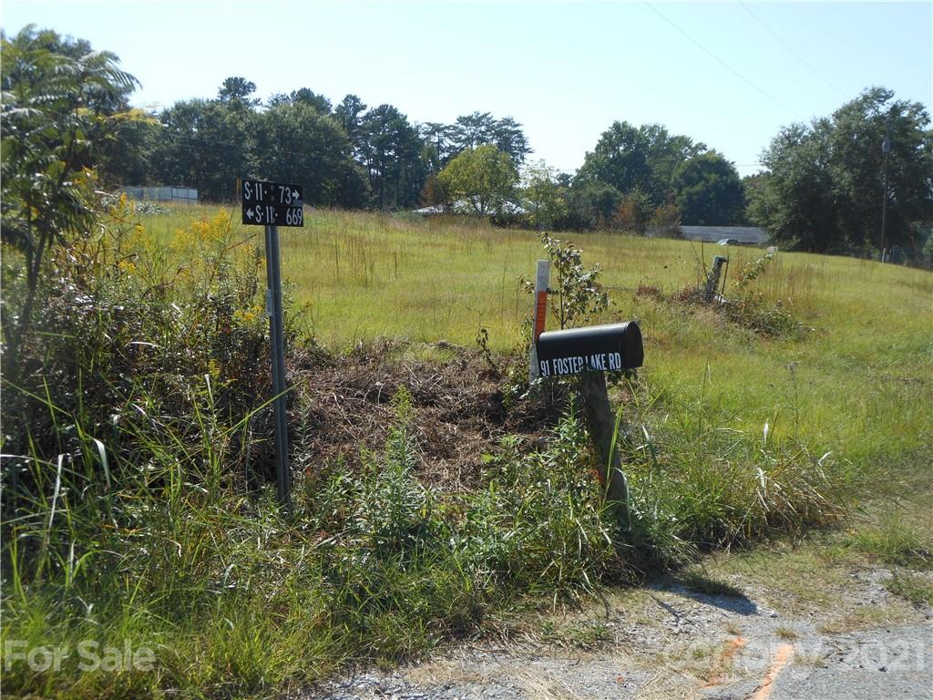 91 Foster Lake Road Blacksburg, SC 29702 - Photo 29 of 31 a view of a lake with a house in the background