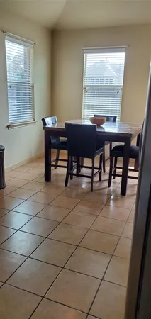 a view of a dining room with furniture and window