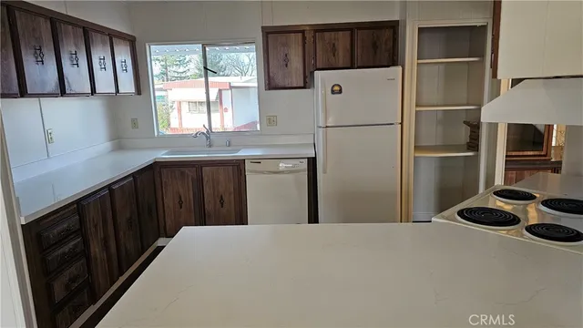 a kitchen with stainless steel appliances a refrigerator and a sink