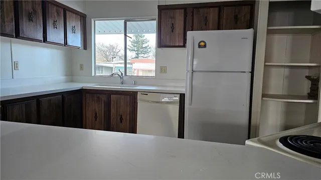 a kitchen with a refrigerator and window