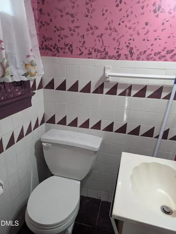 a bathroom with a toilet and a sink