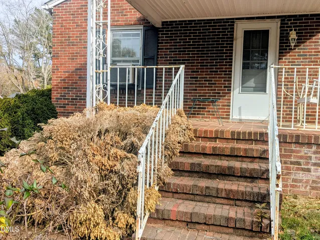 a view of a house with a window and wooden fence