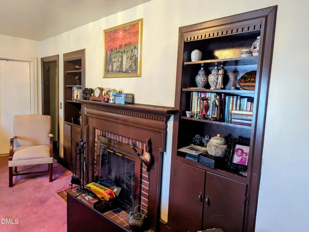 a living room with lots of furniture and baby bed