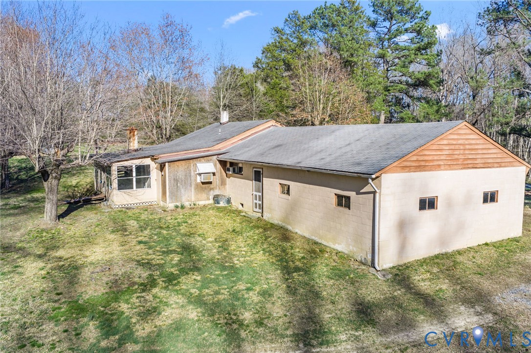 19161 Hollowing Creek Road Beaverdam, VA 23015 - Photo 4 of 27 a view of a white house next to a yard with large trees