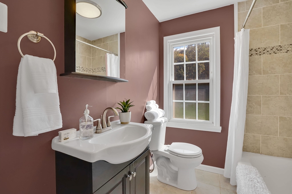 81 Oak Hollow Road Springfield, MA 01128 - Photo 18 of 42 a bathroom with a toilet sink and mirror