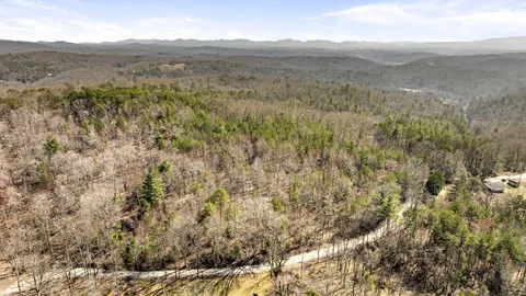 a view of a dry yard with mountains in the background