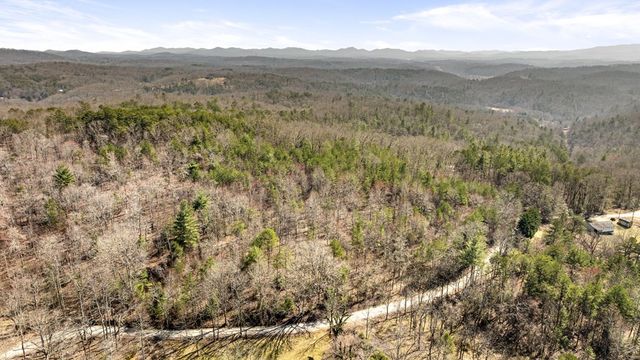 a view of a dry yard with mountains in the background