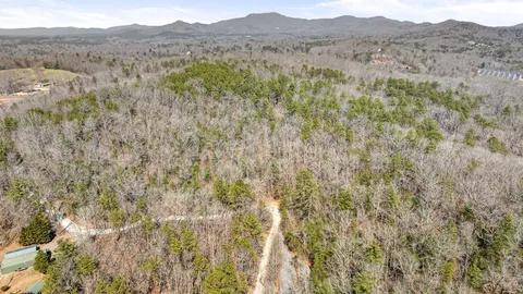 a view of a mountain range with trees in the background
