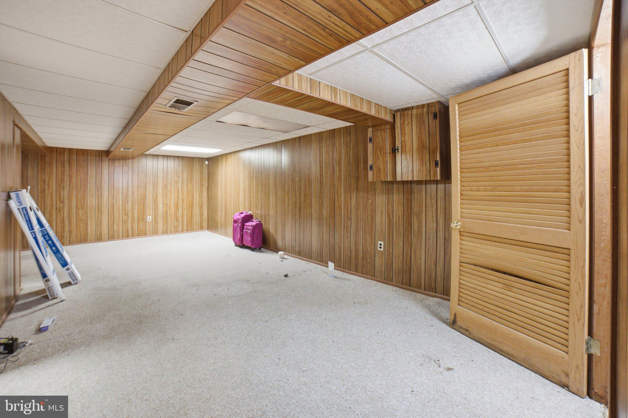 907 Logwood Road Capitol Heights, MD 20743 - Photo 14 of 16 Spacious basement with wood paneling.