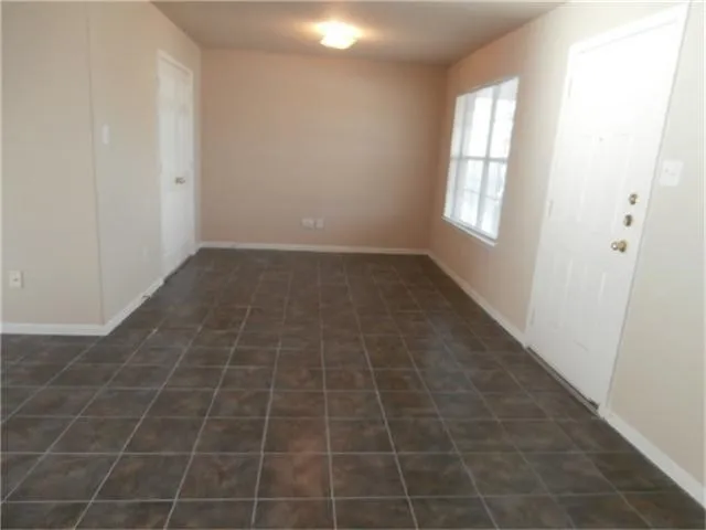 a view of an empty room and a window