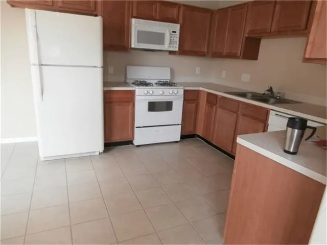 a kitchen with a sink a stove and refrigerator