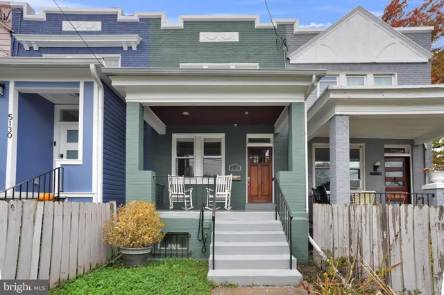 a view of a house with a small yard and a large window