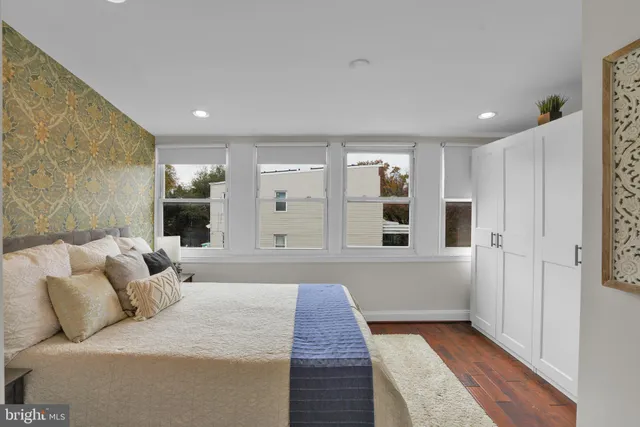 a large bedroom with a bed and glass door