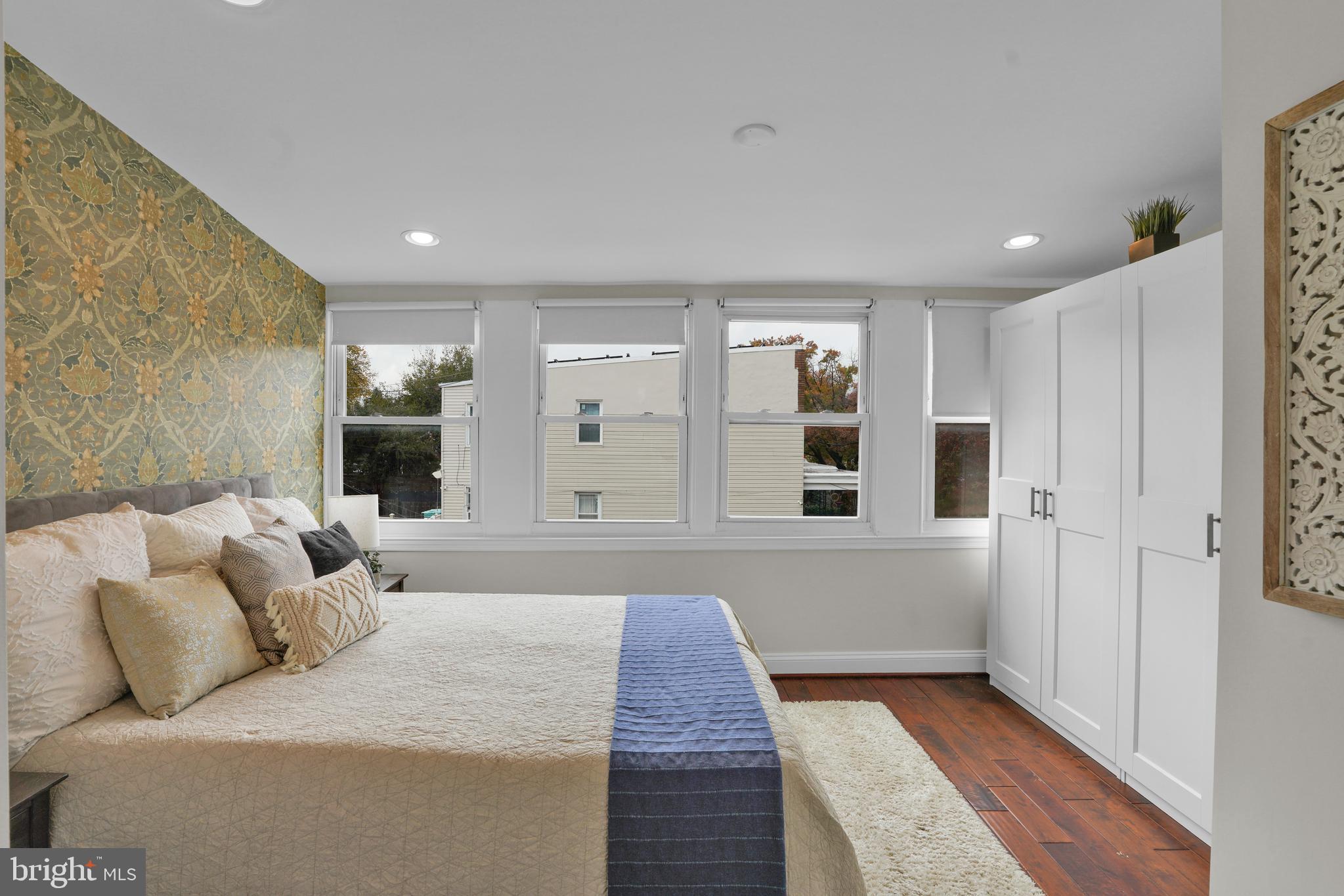 5132 7th Street Northwest Washington, DC 20011 - Photo 12 of 34 a large bedroom with a bed and glass door