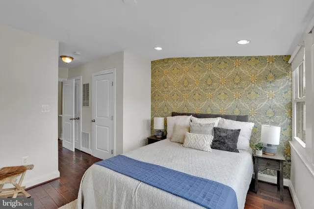 a bedroom with a bed and a painting on the wall